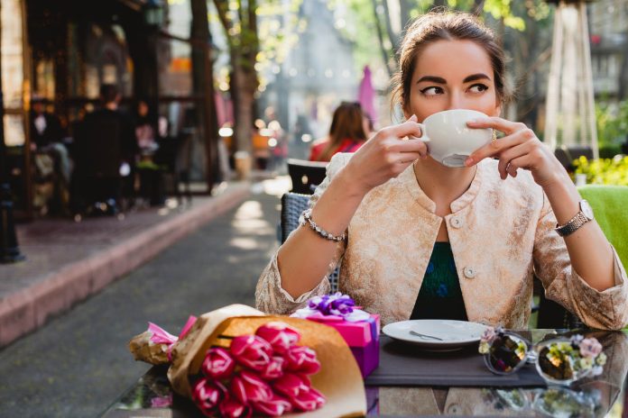 Young,Stylish,Woman,,Fashion,Sunglasses,,Sitting,In,Cafe,,Holding,Drinking